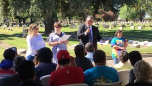 Tony Anderson Executive Director Valley Mountain Regional Center speaking to the audience with a microphone at Parkview Cemetery in Modesto.