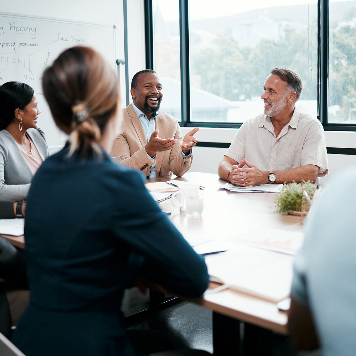 Shot of a group of business people listening to a colleagues ideas during a meeting.