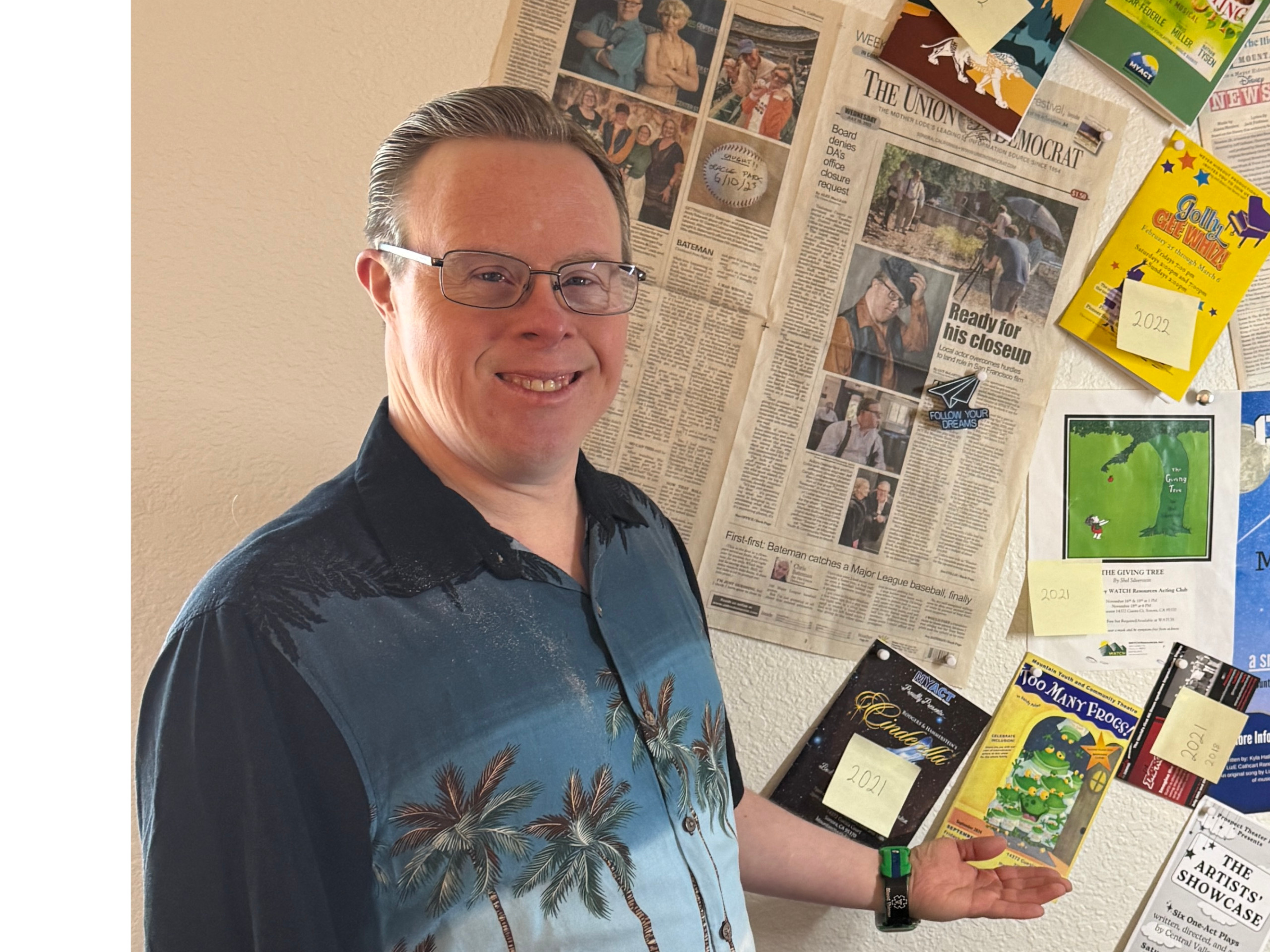 Tim Wall pointing at papers on a wall.